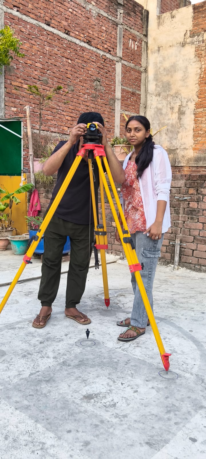 Survey team operating a total station